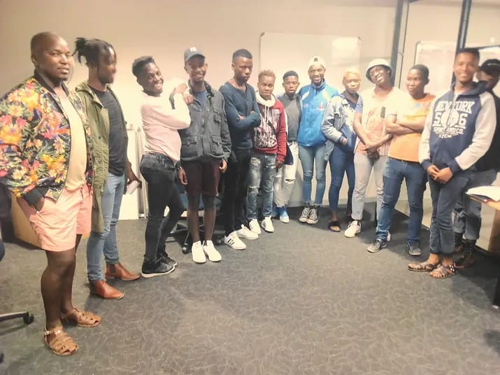 KKQH Community members standing in a semi-circle